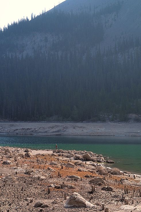 Pêcheur sur les rives asséchées du lac Spray, dans la vallée de Kananaskis.