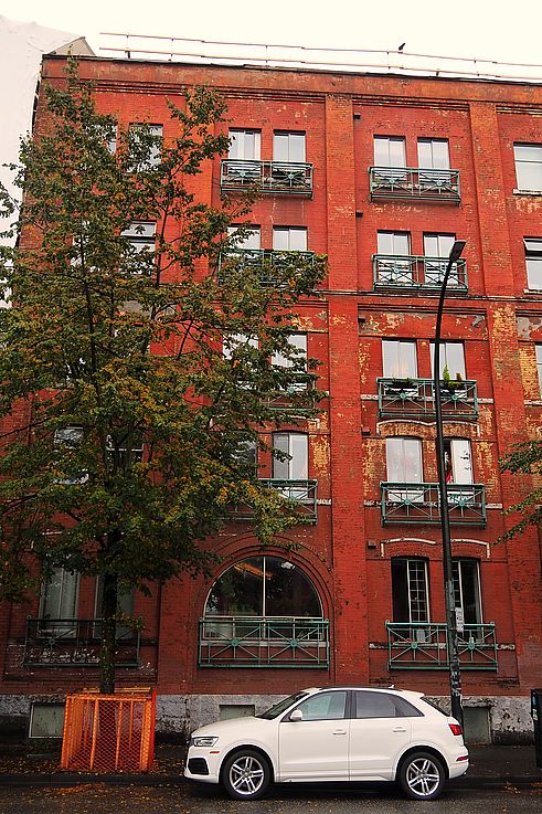 Audi Q3 in front of the red brick Mission House building in the Gastown neighborhood, Vancouver.
