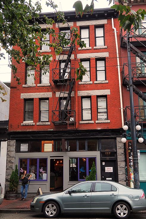 Red brick building with an external fire escape in the historic Gastown district in Vancouver.