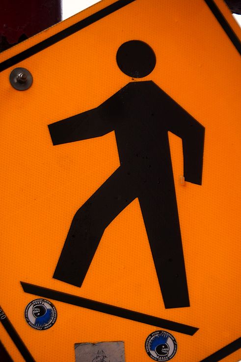 “Vancouver Punk” stickers on a pedestrian signal sign in the Chinatown district.