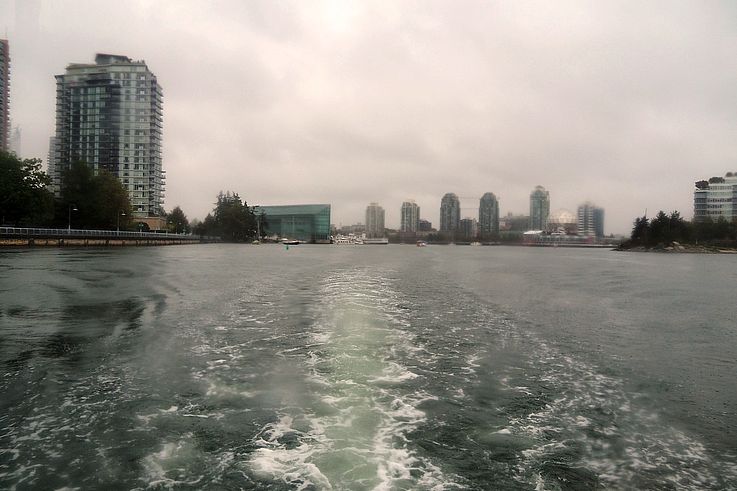 Wake of a ship on False Creek with a view of the Yaletown skyscrapers.