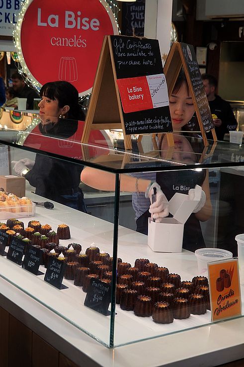 Sale of canelés at La Bise bakery in the Granville Island Public Market in Vancouver.